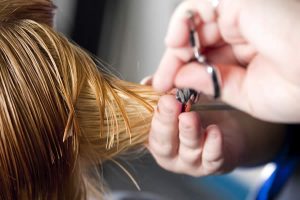 Hands cutting hair